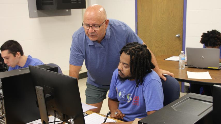 instructor and student at computer