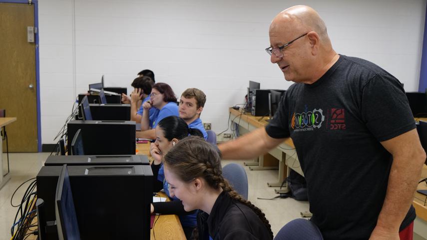 Summer Bridge instructor helping student at computer